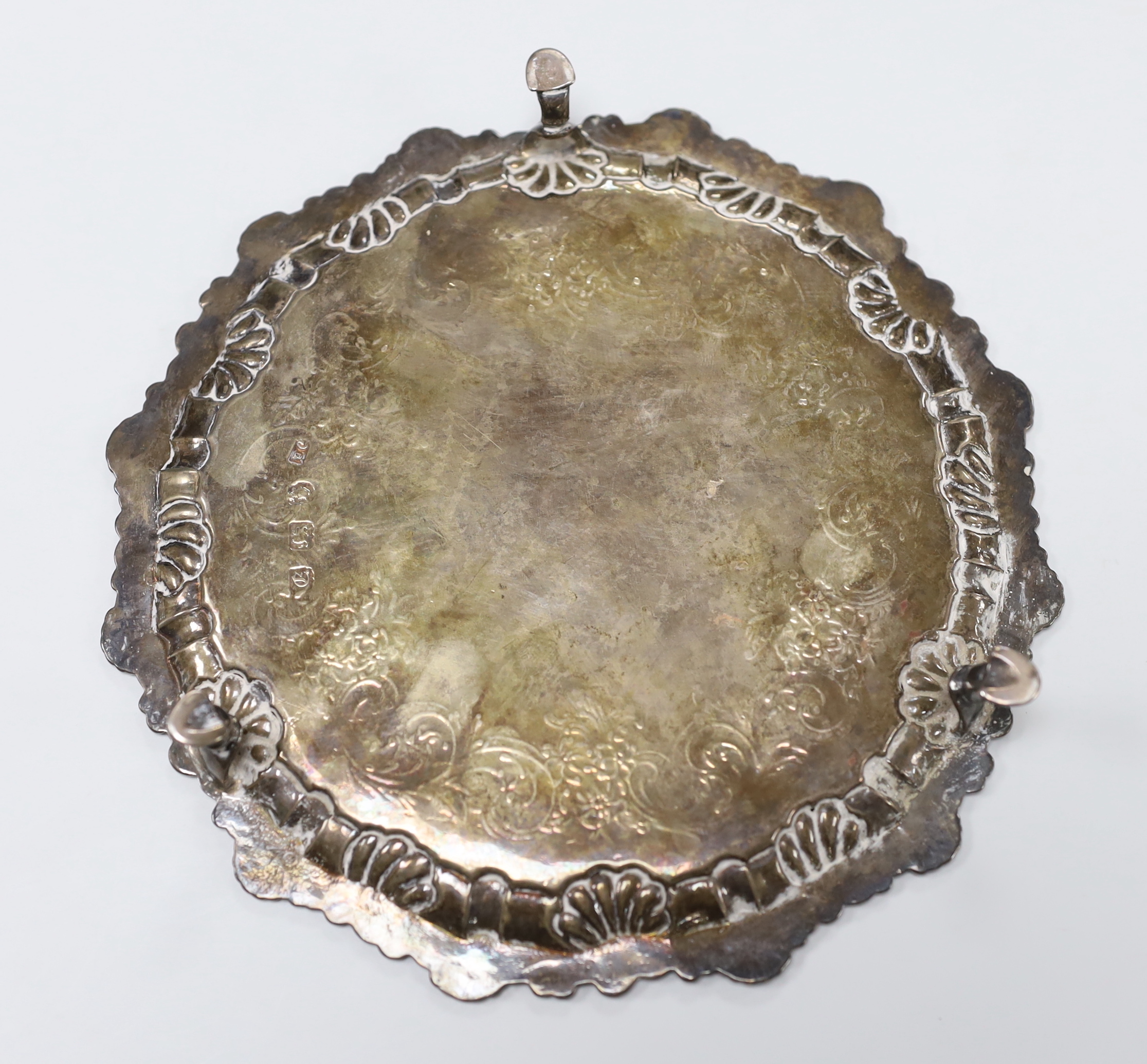 A late George II silver waiter, with engraved crest and later chased decoration, Ebenezer Coker, London, 1758, 19.2cm, 8.4 oz.